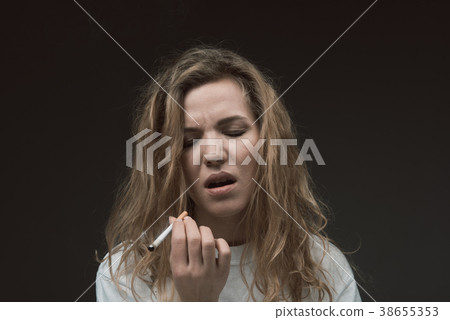 Calm woman enjoying tobacco product Calm woman enjoying tobacco product 38655353