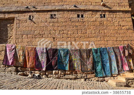 Indian World Heritage Site Jaisalmer Castle Souvenir shop of stray dogs and folk art sitting on the road in the fortress Indian World Heritage Site Jaisalmer Castle Souvenir shop of stray dogs and folk art sitting on the road in the fortress 38655738
