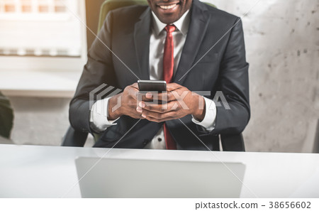 Positive employee is using smartphone Positive employee is using smartphone 38656602