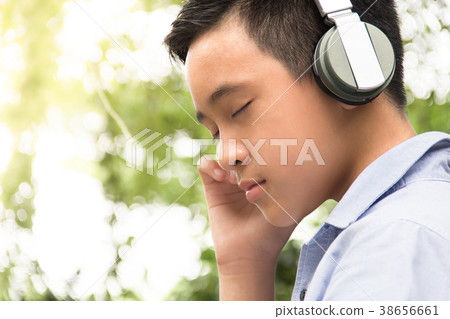 Portrait boy wearing headphones listening music 38656661