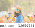 Teachers stand watching students play sports. 38659541