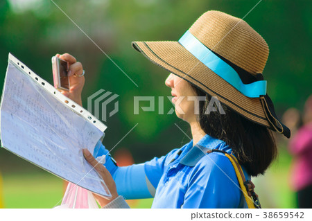 A female teacher is taking a photo of  school . 38659542