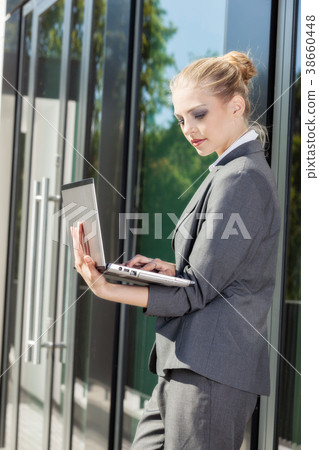Young and attractive businesswoman working on laptop Young and attractive businesswoman working on laptop 38660448