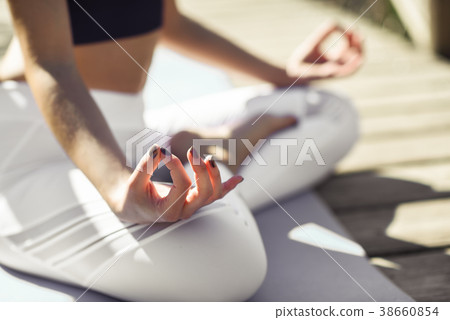 Young beautiful woman doing yoga in nature Young beautiful woman doing yoga in nature 38660854