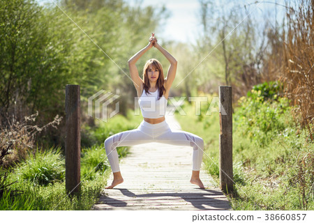 Young beautiful woman doing yoga in nature Young beautiful woman doing yoga in nature 38660857