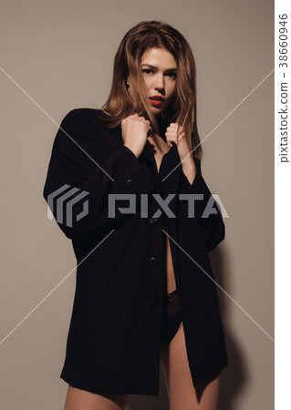 Young attractive woman posing in a man's jacket Young attractive woman posing in a man's jacket 38660946
