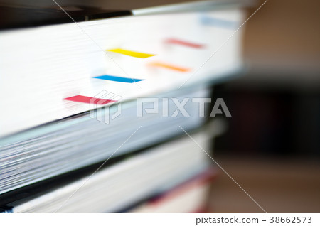 A book with a bookmark placed on the desk 38662573