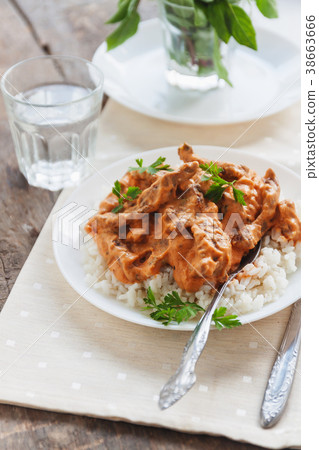 Dish rice with beef stroganoff on a white plate 38663666