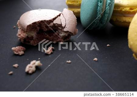Crumbled macaroons on stylish dark background Crumbled macaroons on stylish dark background 38665114