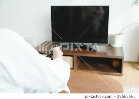 Woman watching TV in the living room 38665565