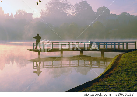 man do exercise,  lake in fog 38666138