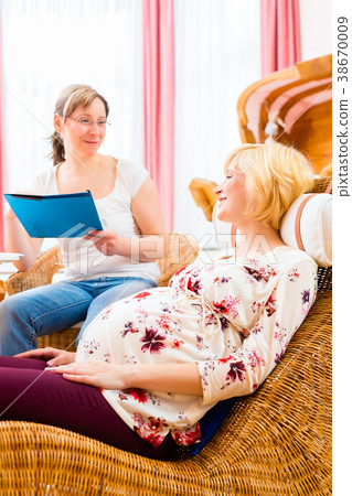 Midwife seeing pregnant mother in practice 38670009