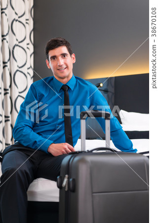 Businessman at arrival in hotel room 38670108
