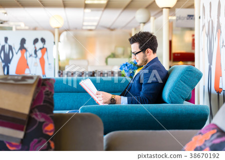 Man buying couch in furniture store Man buying couch in furniture store 38670192