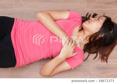 Sporty woman having heart attack at park Sporty woman having heart attack at park 38671373