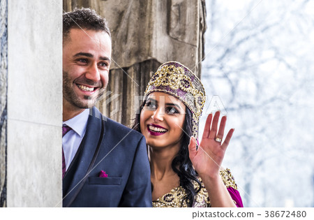 Happy couple in traditional turkish wedding dress 38672480