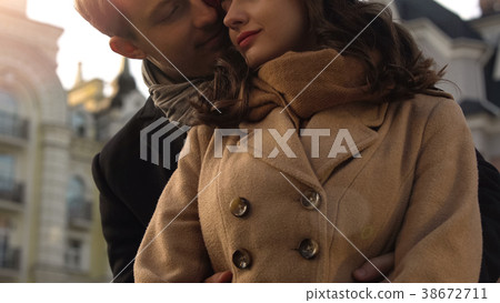 Young couple on date, guy embracing his girlfriend 38672711