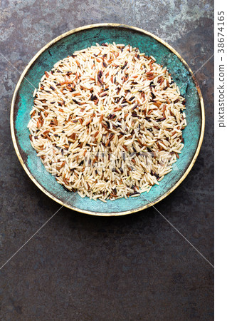 White, brown and black wild rice. Rice in bowl. White, brown and black wild rice. Rice in bowl. 38674165