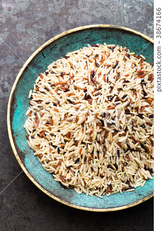 White, brown and black wild rice. Rice in bowl. White, brown and black wild rice. Rice in bowl. 38674166
