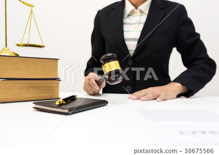 Female lawyer holding wooden dark gavel in office 38675566