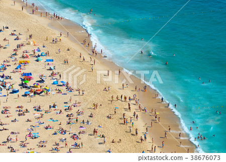 Crowd people ocean beach.  Portugal 38676073