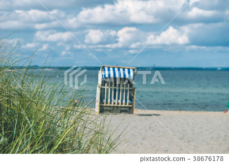 Dune with some grass and traditional wooden beach 38676178