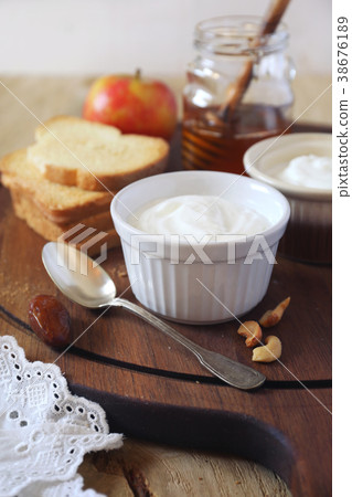 Breakfast. Natural yoghurt, toasts and honey Breakfast. Natural yoghurt, toasts and honey 38676189