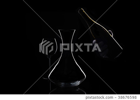 Hand in white glove holds bottle of wine and Hand in white glove holds bottle of wine and 38676598
