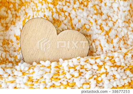 Wooden heart in a knitted textured hand-made 38677253