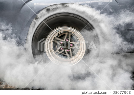 Drag racing car burns tire at startline Drag racing car burns tire at startline 38677908