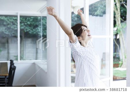 A woman by the window A woman by the window 38681718