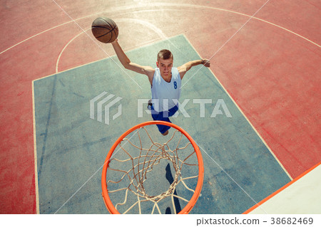 High angle view of basketball player dunking 38682469