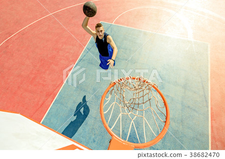High angle view of basketball player dunking High angle view of basketball player dunking 38682470