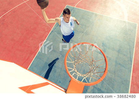 High angle view of basketball player dunking 38682480