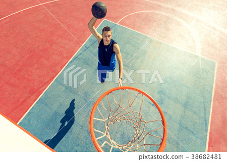 High angle view of basketball player dunking High angle view of basketball player dunking 38682481