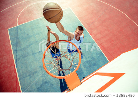 High angle view of basketball player dunking High angle view of basketball player dunking 38682486