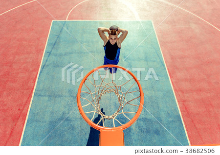 High angle view of basketball player dunking High angle view of basketball player dunking 38682506