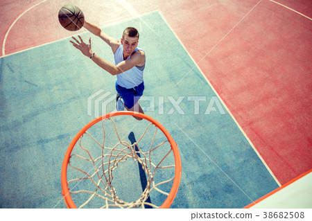 High angle view of basketball player dunking High angle view of basketball player dunking 38682508