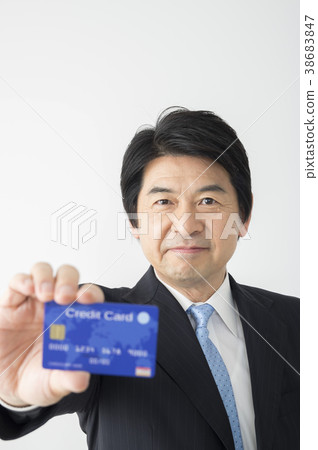 Middle businessman showing a credit card Middle businessman showing a credit card 38683847