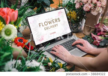 Woman using interface of flower shop Woman using interface of flower shop 38684322