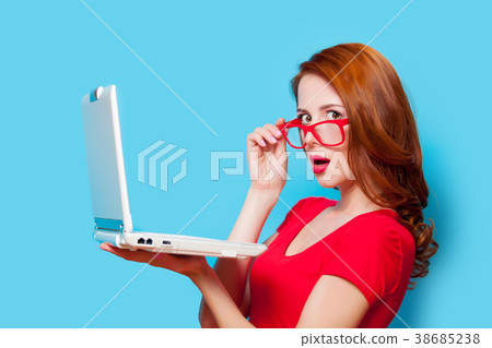 Young beautfiul redhead girl in eyeglasses with laptop computer 38685238