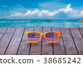 Sunglasses with american flag on wooden table 38685242