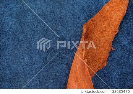 Close up orange rough edge and navy blue leather Close up orange rough edge and navy blue leather 38685470