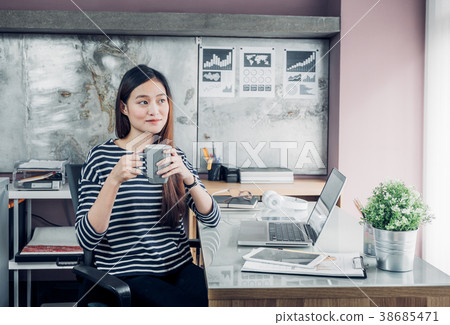 Asian businesswoman take a coffee break after work Asian businesswoman take a coffee break after work 38685471