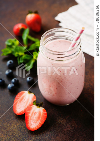 Pink berry smoothie in jar on dark background Pink berry smoothie in jar on dark background 38686266