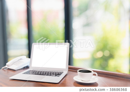 Laptops with white coffee mug on wooden desk Laptops with white coffee mug on wooden desk 38686368