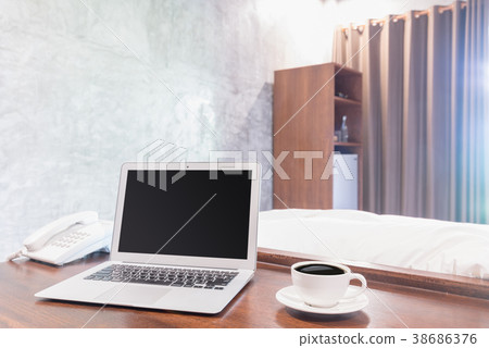 Laptops with white coffee mug on wooden desk Laptops with white coffee mug on wooden desk 38686376