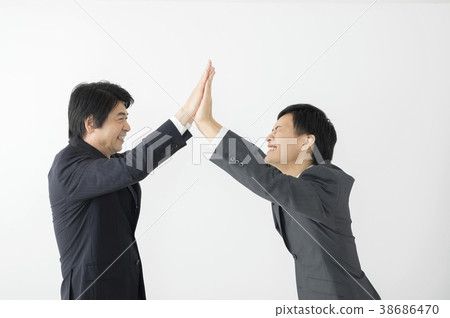 Young businessman and middle businessman doing high touch Young businessman and middle businessman doing high touch 38686470