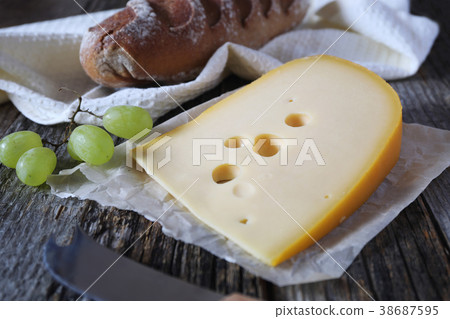 Maasdam cheese, french bread and grapes Maasdam cheese, french bread and grapes 38687595