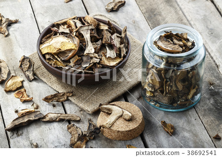 dried mushrooms on a wooden background dried mushrooms on a wooden background 38692541